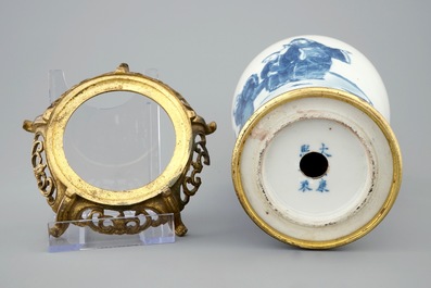 A Chinese blue and white meiping vase on gilt bronze stand, 19th C.